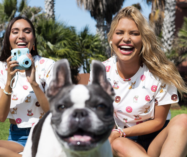 Muscles and Donuts sweetest tees ever. 2 models wearing our cute tees with dogs and donuts all over them and the cutest french bulldog face in the front of the camera